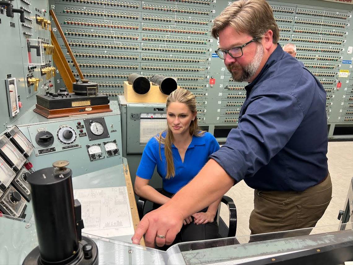 Miss America 2023 Grace Stanke sits at the control panel of historic B Reactor at Hanford as she is briefed by Patrick Jaynes, operations manager at the Manhattan Project National Historical Park, in May.