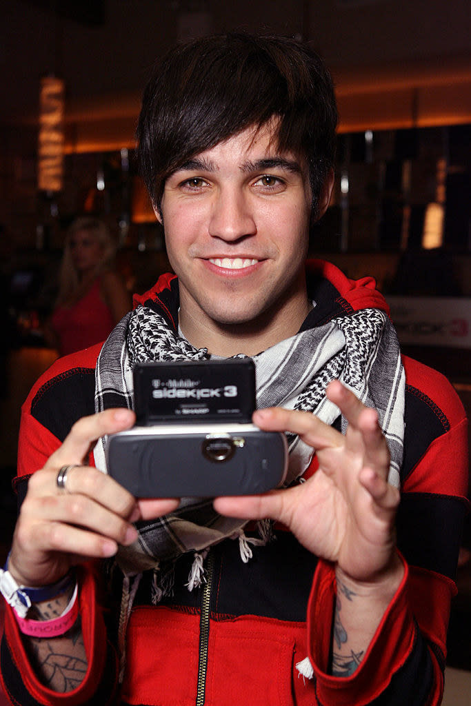 Pete Wentz holding up his phone