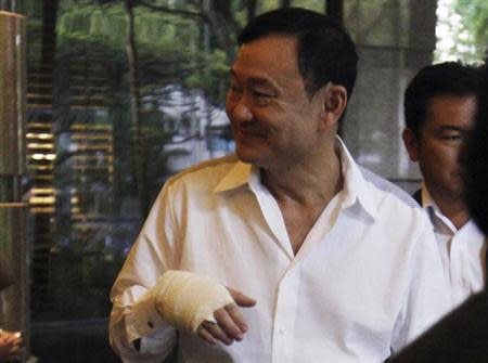 Thailand's former prime minister Thaksin Shinawatra sports a bandaged hand as he leaves a meeting at a hotel in Singapore January 27, 2014. REUTERS/Edgar Su