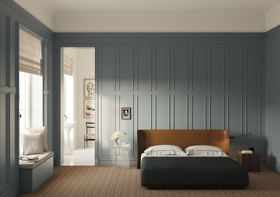 A bedroom with wall panelling