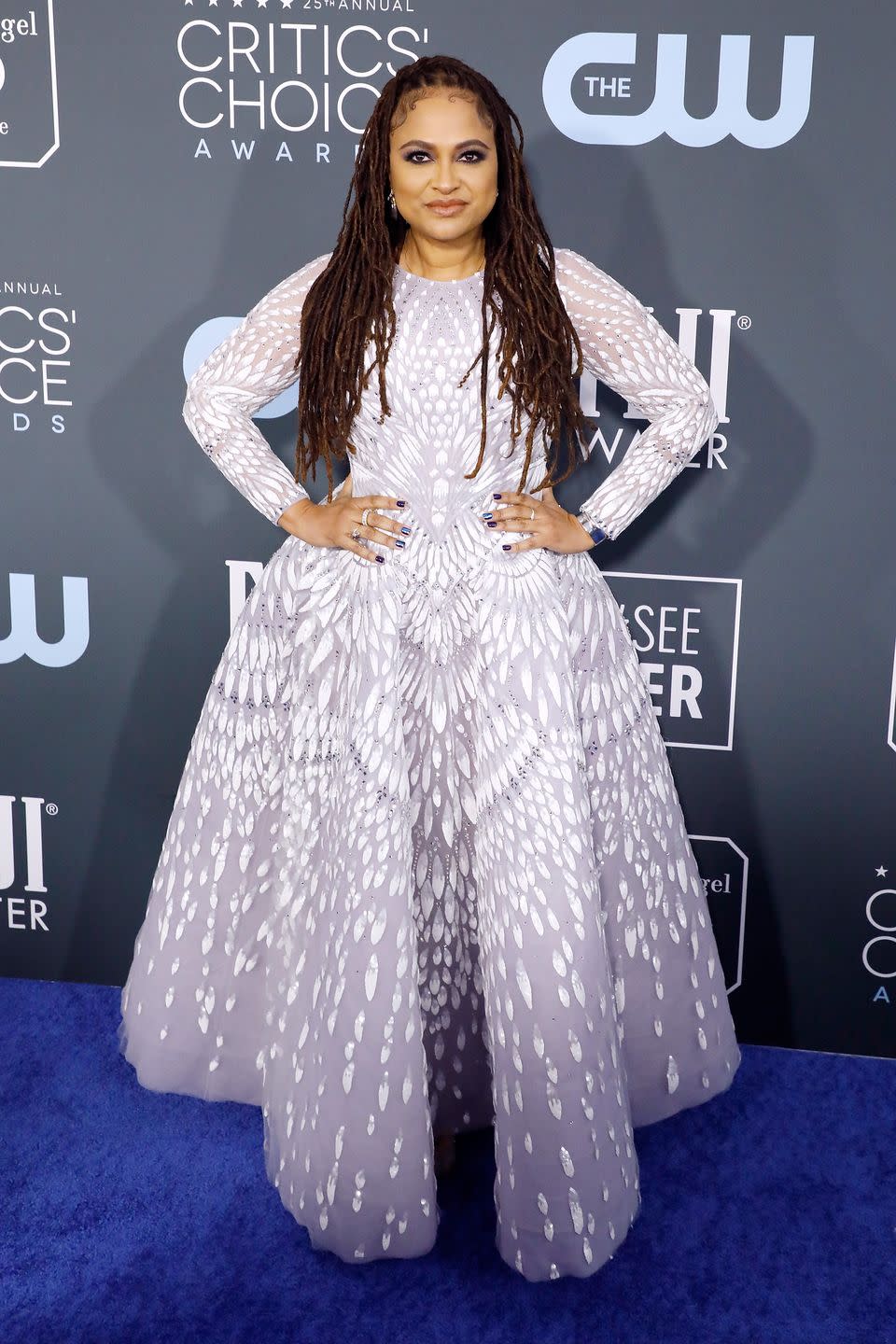 <p>Ava DuVernay smiles in a long-sleeved lavender dress, featuring white embellishments, and <a href="https://www.kurtgeiger.com/women/shoes/courts/bond-pink-fabric-kurt-geiger-london-1450698609" rel="nofollow noopener" target="_blank" data-ylk="slk:heels by Kurt Geiger;elm:context_link;itc:0;sec:content-canvas" class="link ">heels by Kurt Geiger</a>.</p>