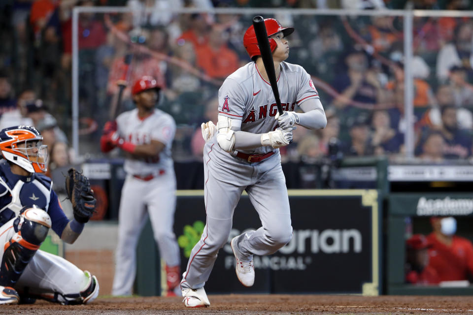 Los Angeles Angels designated hitter Shohei Ohtani, right, watches his home run hit in front of Houston Astros catcher Martin Maldonado, left, during the eighth inning of a baseball game Sunday, April 25, 2021, in Houston. (AP Photo/Michael Wyke)