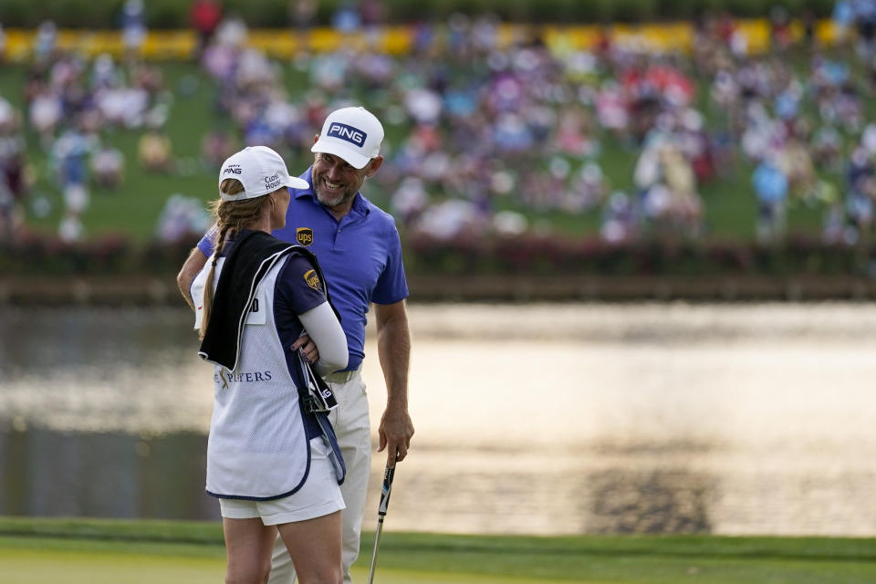 Lee Westwood, of England, talks with his caddie Helen Storey on the 16th green during the third round of The Players Championship golf tournament Saturday, March 13, 2021, in Ponte Vedra Beach, Fla. (AP Photo/Gerald Herbert)