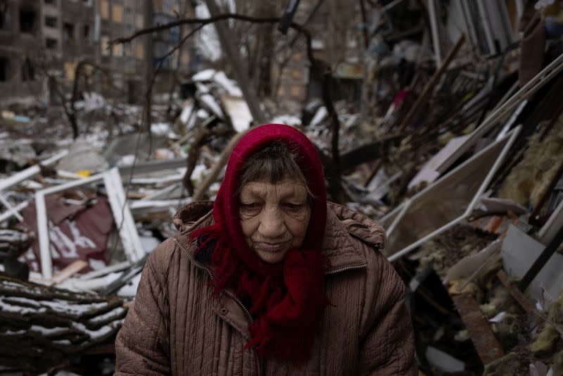 Raisa Nazarenko stands in front of her shattered ground floor apartment that was damaged as a result of a Russian missile strike in Selydove near Avdiivka