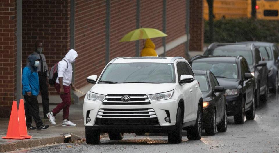 Students leave Carnage Middle School just after 12:30 p.m. on Nov. 12, 2020 in Raleigh after the Wake County school system closed schools two hours early due heavy rain and potential flooding.