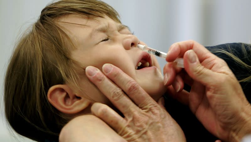 In this Oct. 4, 2005, file photo, a child reacts as she is given a FluMist influenza vaccination in St. Leonard, Md.