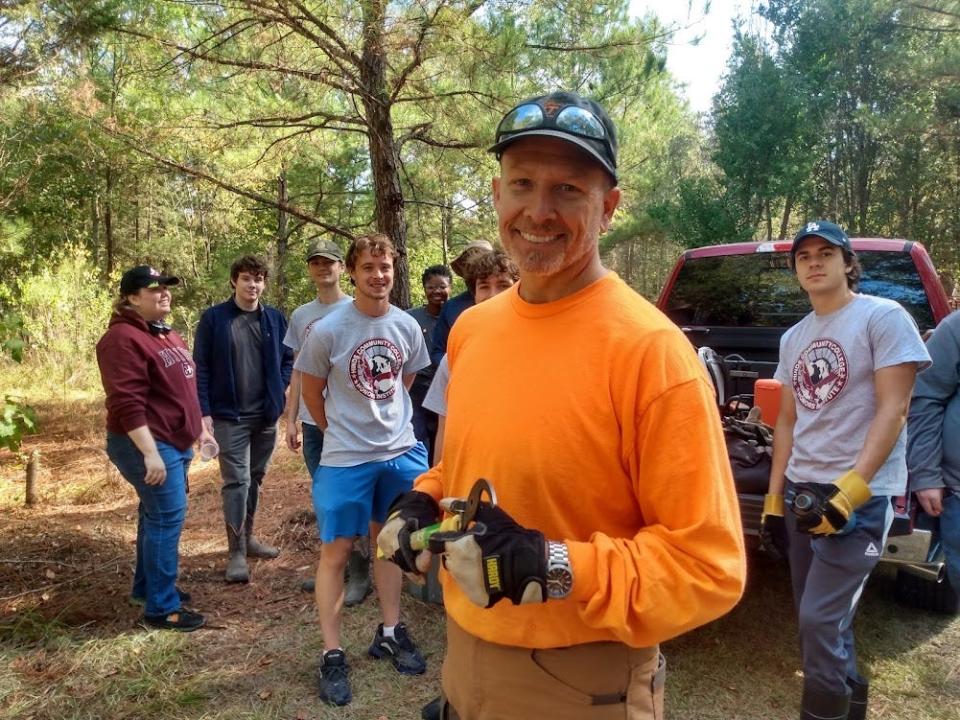 Friends of the Mississippi River Basin Model President Aaron Morris, foreground, makes preparations for the site’s 80th Anniversary Celebration this Saturday as volunteers from Hinds Community College look on.