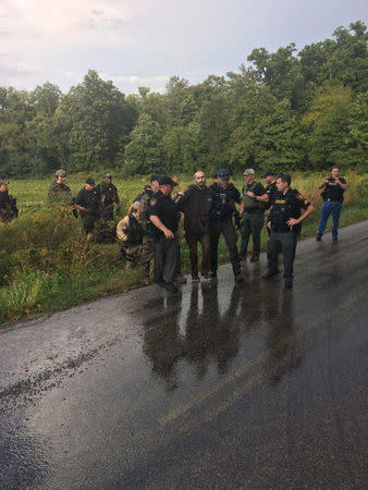 Fugitive Shawn Christy, 27, is arrested by law enforcement agents in Mifflin Township, Ohio, U.S. in this September 21, 2018 handout photo. He has been charged with threatening President Donald Trump. U.S. Marshal's Service/Handout via REUTERS