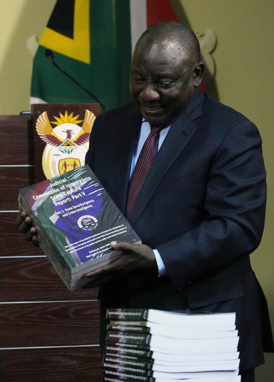 South Africa's President Cyril Ramaphosa receives the final report of a judicial investigation into corruption from Chief Justice Raymond Zondo at Union Building in Pretoria, South Africa, Wednesday, June 22, 2022.The probe has laid bare the rampant corruption in government and state-owned companies during former President Jacob Zuma’s tenure from 2009 to 2018. (AP Photo/Themba Hadebe)