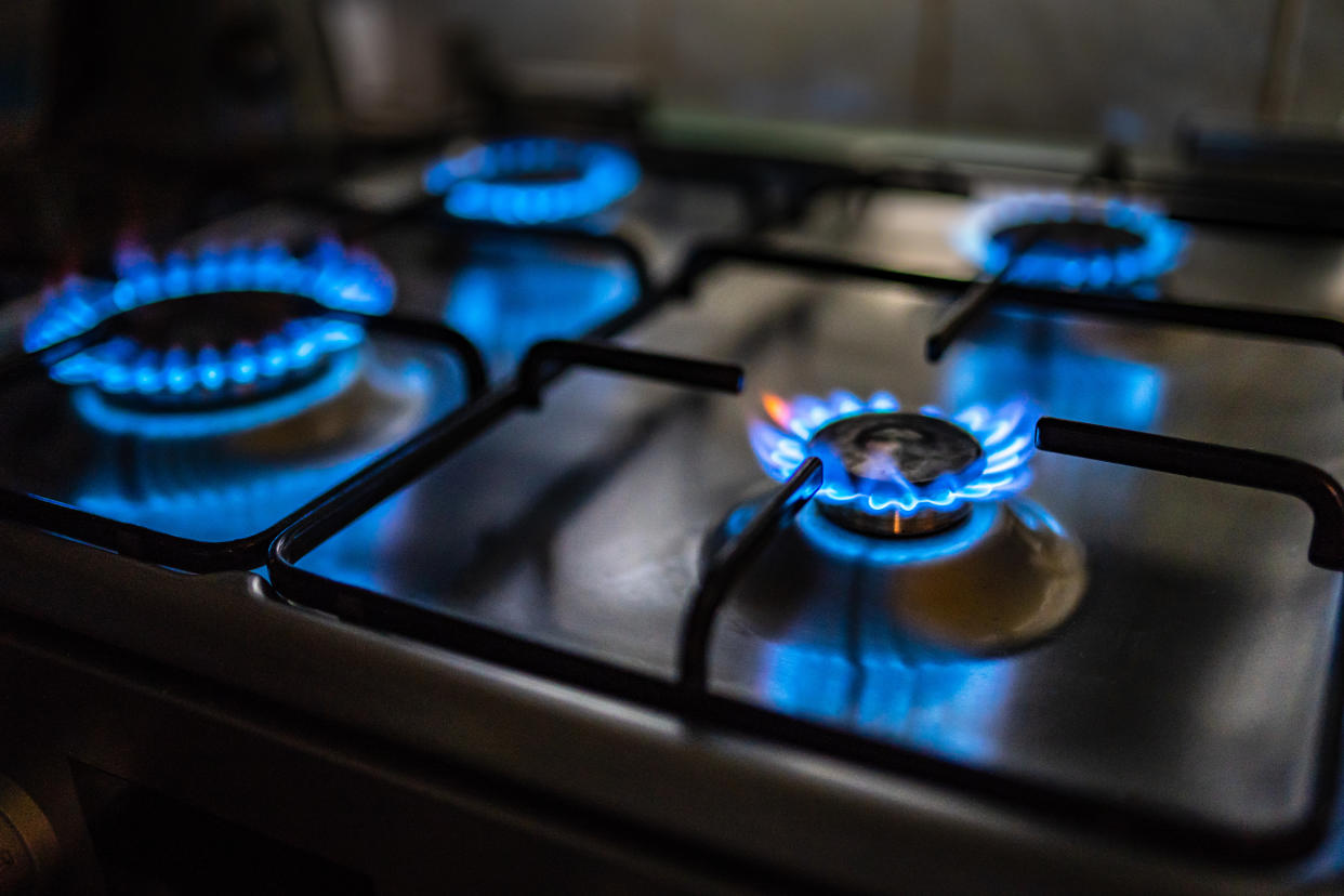 A close-up of a gas stove with all four burners turned on. (Getty Images)