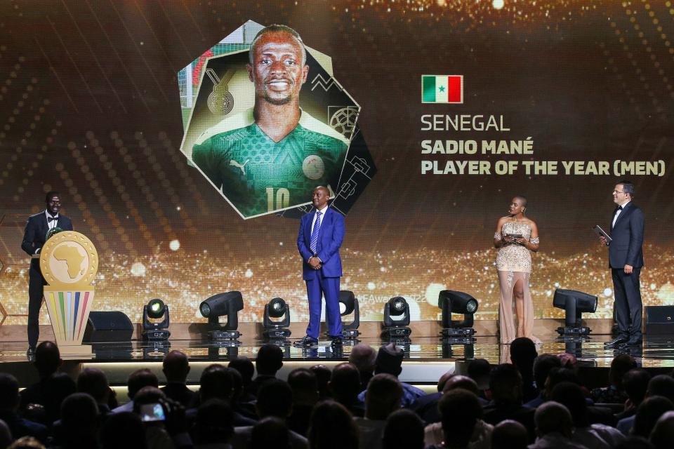 Senegalese forward Sadio Mane (L) speaks after winning the Men's Player of the Year, in the presence of CAF President Patrice Motsepe (2nd-L), during the 2022 Confederation of African Football (CAF) Awards on July 21, 2022, in the Moroccan capital Rabat. (Photo by AFP) (Photo by -/AFP via Getty Images)