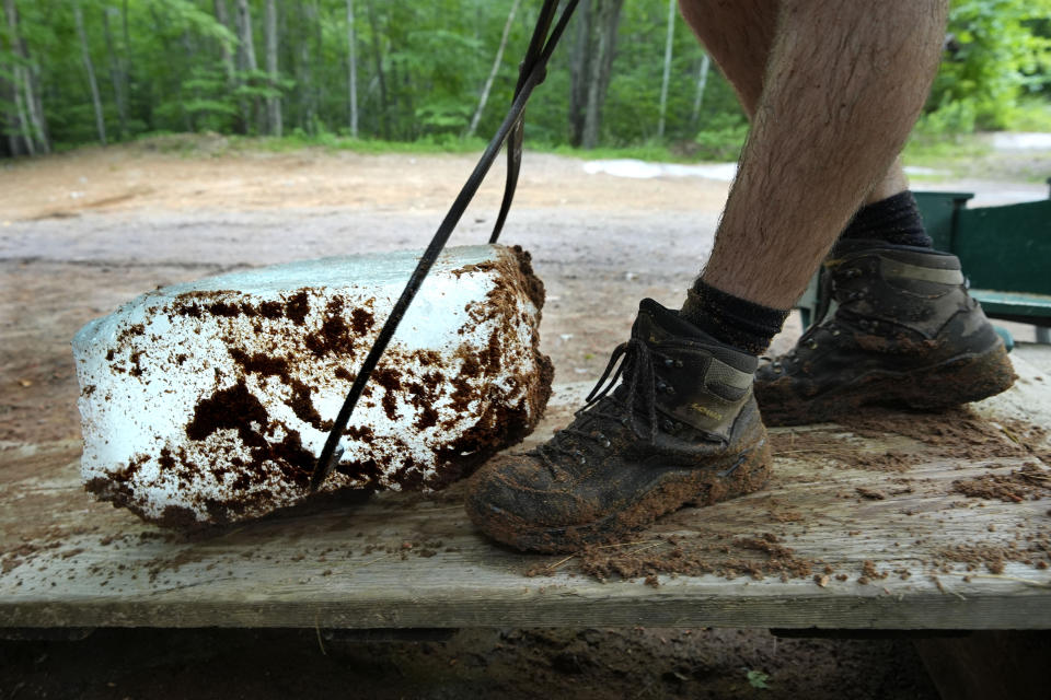 A block of ice is hauled up a the loading ramp at Rockywold Deephaven Camps, Thursday, June 20, 2024, in Holderness, N.H. Sawdust used to insulated the ice will be washed off before it is delivered to guest cabins. (AP Photo/Robert F. Bukaty)