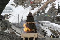 The Boeoegg, a snowman, stands atop of a bonfire on Devil's Bridge near Andermatt