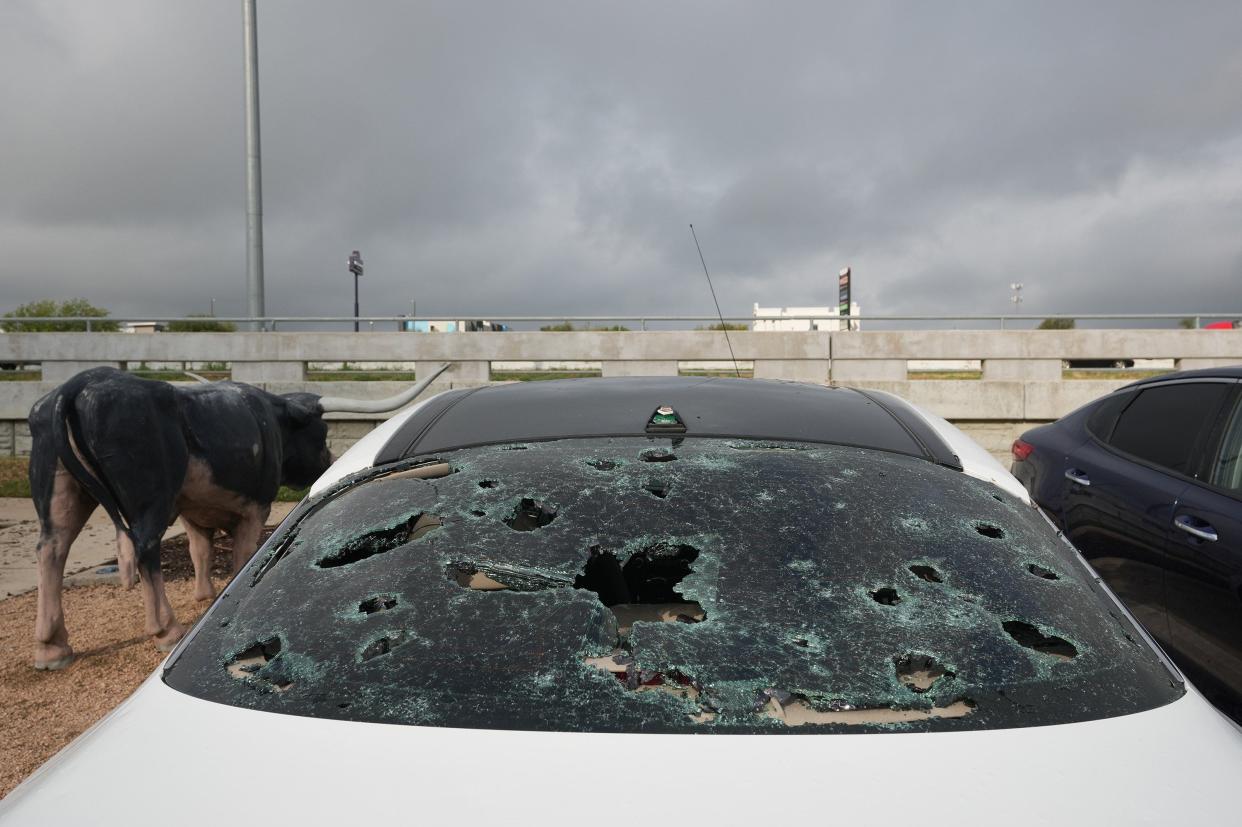 Hail-damaged cars sit on the lot at Kia of Round Rock on Sept. 25 after a destructive storm the night before. Officials say the storm caused $70 million in damage to Round Rock school district facilities.