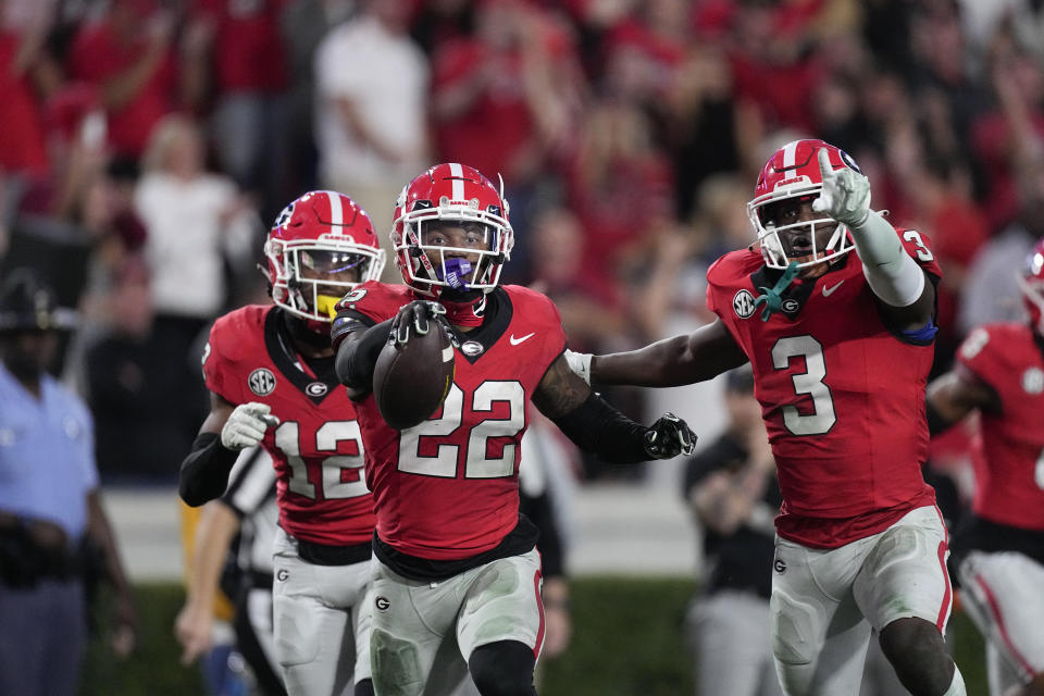 Georgia defensive back Javon Bullard (22) celebrates with Kamari Lassiter (3) and Julian Humphrey (12) after intercepting a pass during the second half of an NCAA college football game against Missouri, Saturday, Nov. 4, 2023, in Athens, Ga. (AP Photo/John Bazemore)