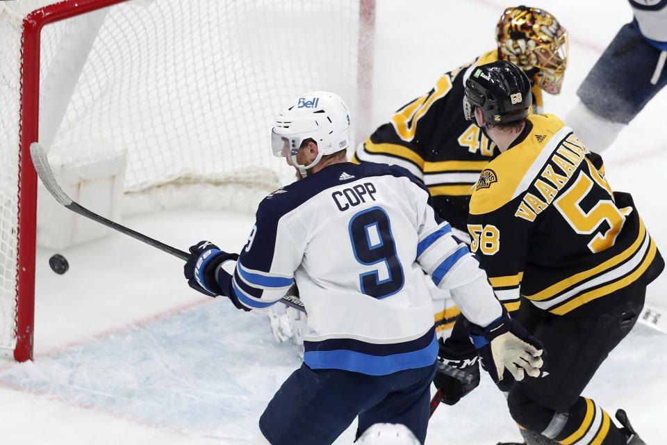 Winnipeg Jets' Andrew Copp (9) scores on Boston Bruins' Tuukka Rask (40) during the first period of an NHL hockey game, Saturday, Jan. 22, 2022, in Boston. (AP Photo/Michael Dwyer)