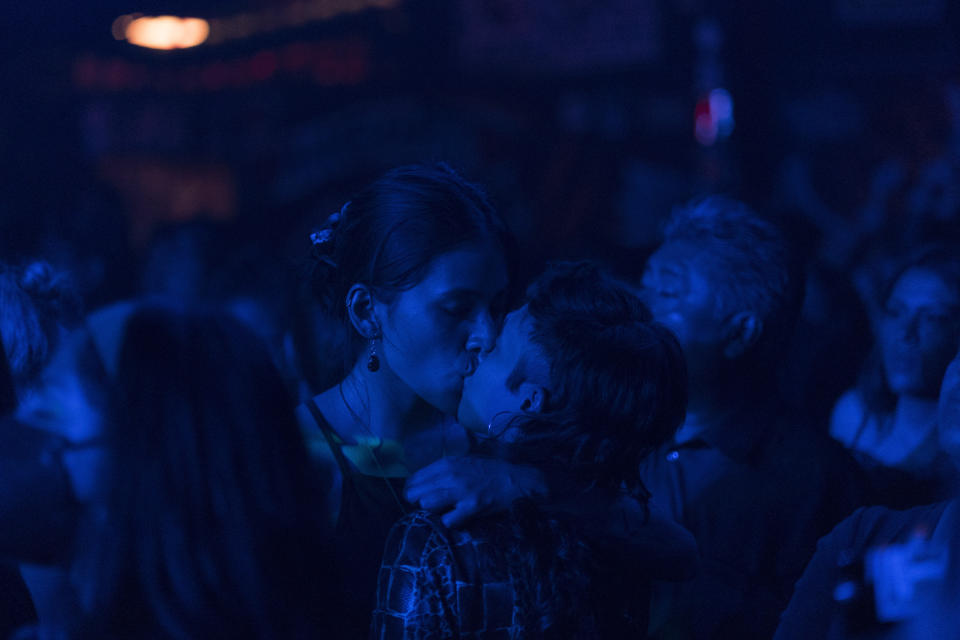 A couple kisses during one of the last active weekends at the iconic counterculture venue Multiforo Alicia in Mexico City, Friday, Feb. 24, 2023. The name of the venue comes from an Italian counterculture radio station from the 1970s, Radio Alice, and Lewis Carrol’s Alice in Wonderland. (AP Photo/Eduardo Verdugo)