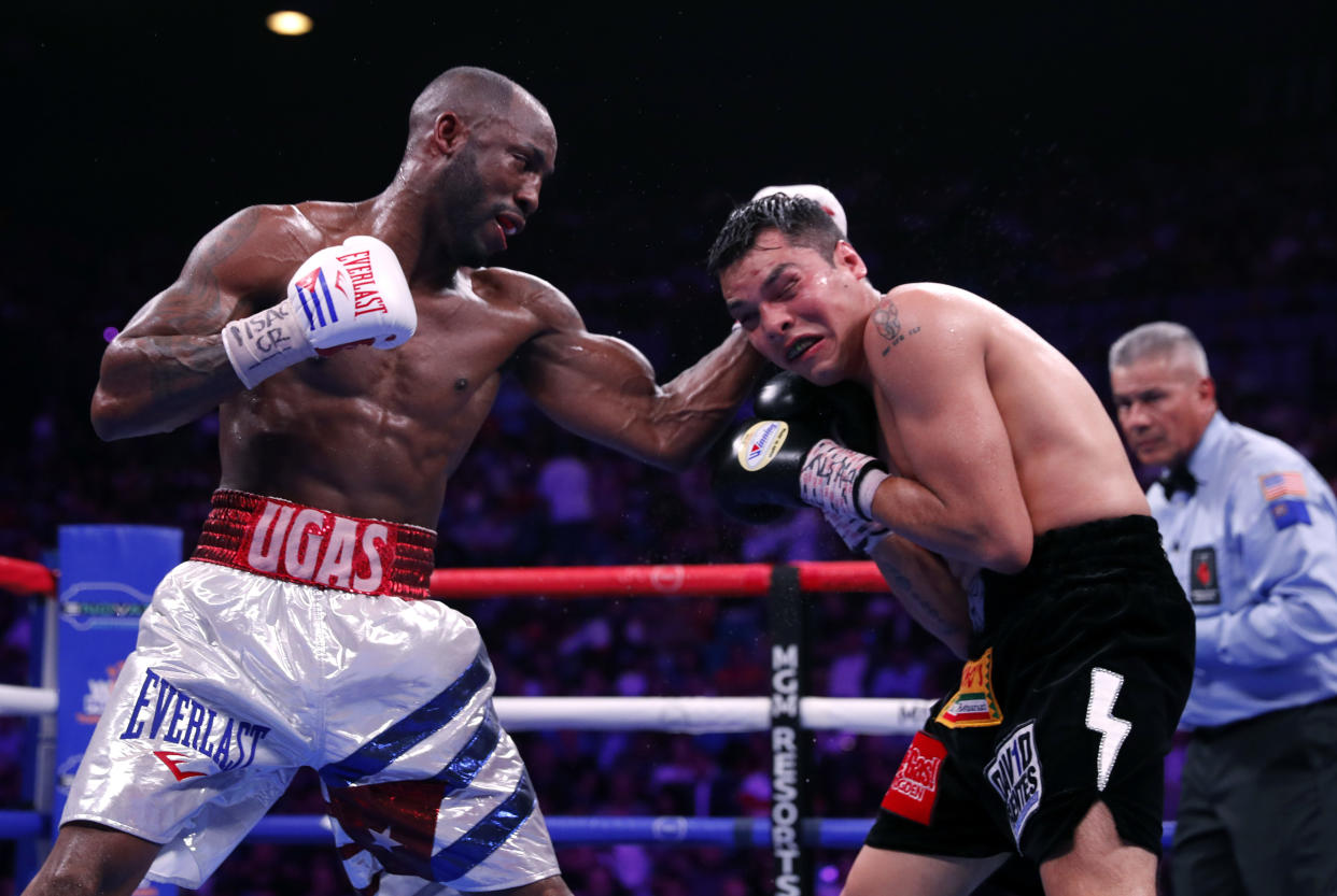 LAS VEGAS, NEVADA - JULY 20:  Yordenis Ugas  (L) punches Omar Figueroa Jr. during a welterweight bout at MGM Grand Garden Arena on July 20, 2019 in Las Vegas, Nevada. Ugas won the fight by unanimous decision. (Photo by Steve Marcus/Getty Images)