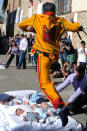 BURGOS, SPAIN - JUNE 10: A man representing the devil leaps over babies during the festival of El Colacho on June 10, 2012 in Castrillo de Murcia near Burgos, Spain. The festival, held on the first Sunday after Corpus Cristi, represents the devil taking away original sin from the newly born babies by leaping over them. (Photo by Denis Doyle/Getty Images)