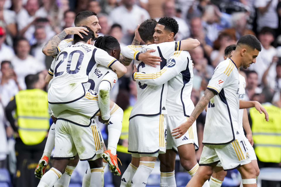 Real Madrid's Jude Bellingham, center right, celebrates after scoring his side's second goal during the the Spanish La Liga soccer match between Real Madrid and Cadiz at the Santiago Bernabeu stadium in Madrid, Spain, Saturday, May 4, 2024. (AP Photo/Manu Fernandez)