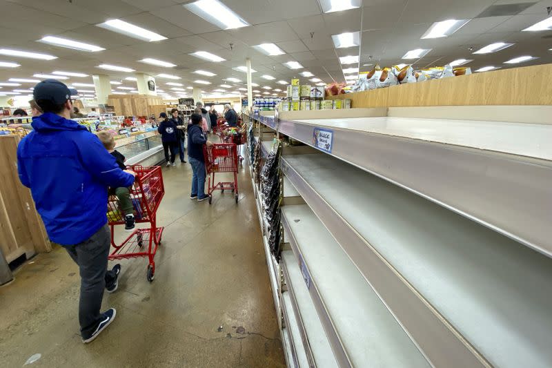 Shelves previously filled with pasta and canned food are seen empty at a Trader Joe's grocery store as shoppers gather supplies with coronavirus fears spreading in Encinitas, California