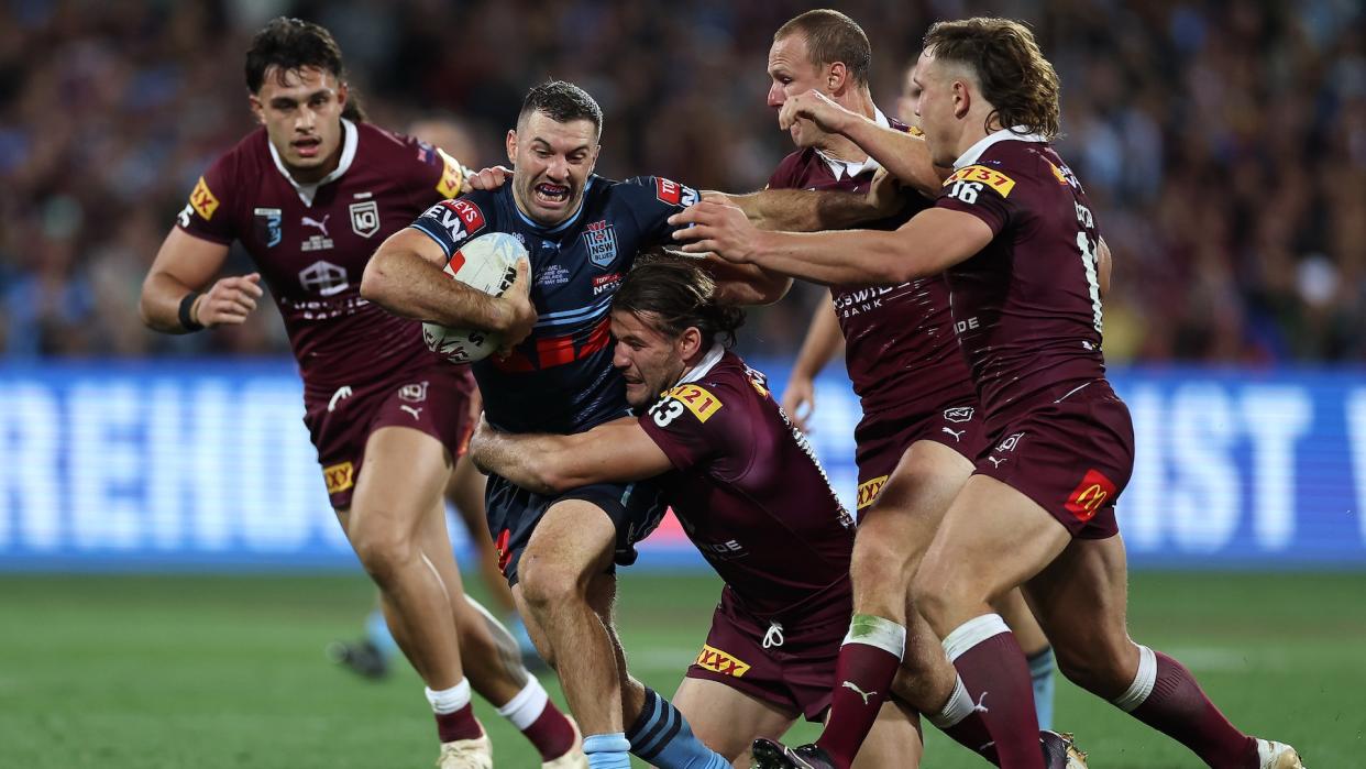  James Tedesco of the NSW Blues is tackled during game one of the State of Origin series 2023 