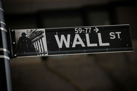 A Wall St. street sign is seen near the New York Stock Exchange (NYSE) in New York City, U.S., March 7, 2019. REUTERS/Brendan McDermid