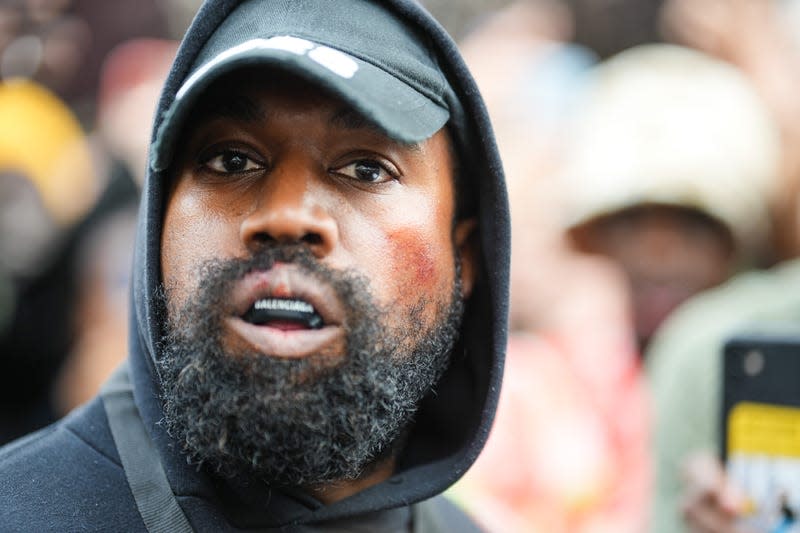 Kanye West aka Ye is seen wearing a Balenciaga boxing mouthguard, outside Givenchy, during Paris Fashion Week - Womenswear Spring/Summer 2023 - Day Seven on October 02, 2022 in Paris, France. 