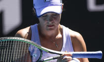Australia's Ash Barty wipes the sweat from her racket during her quarterfinal match against Karolina Muchova of the Czech Republic at the Australian Open tennis championship in Melbourne, Australia, Wednesday, Feb. 17, 2021.(AP Photo/Andy Brownbill)