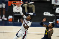 Gonzaga's Joel Ayayi (11) shoots in front of West Virginia's Gabe Osabuohien during the second half of an NCAA college basketball game Wednesday, Dec. 2, 2020, in Indianapolis. (AP Photo/Darron Cummings)