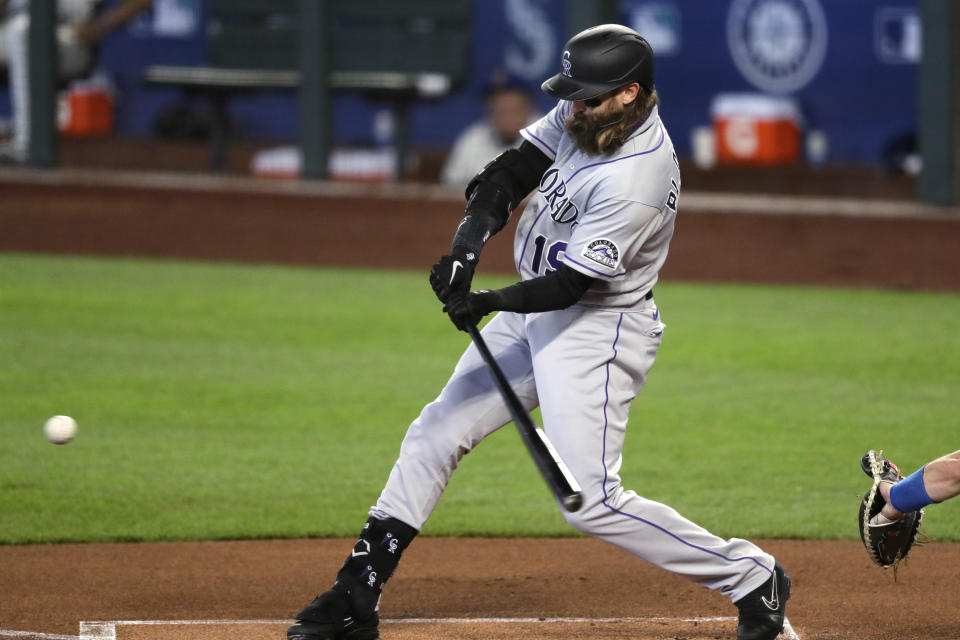 Colorado Rockies' Charlie Blackmon doubles against the Seattle Mariners in the first inning of a baseball game Sunday, Aug. 9, 2020, in Seattle. (AP Photo/Elaine Thompson)