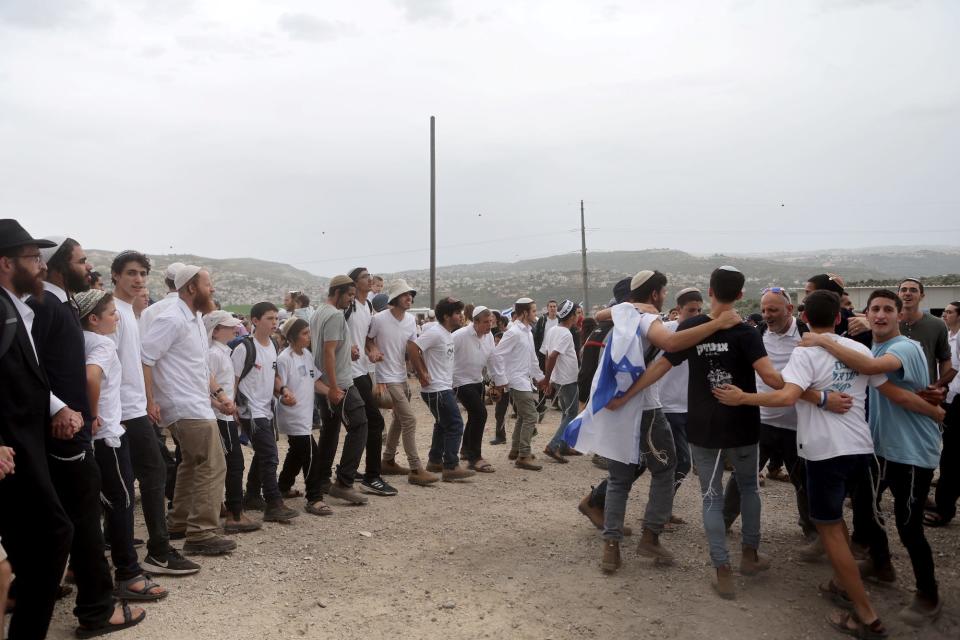 Israeli settlers hold a protest march.