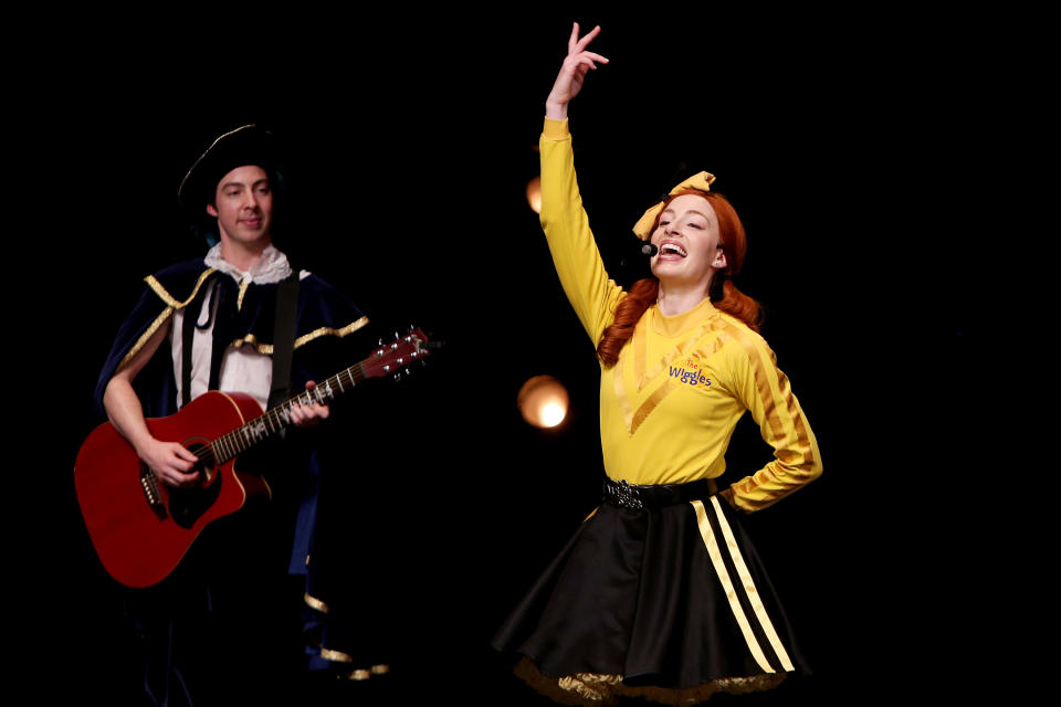 The Wiggles on stage, with Emma singing