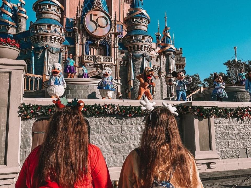 two people watching the castle show at disney world