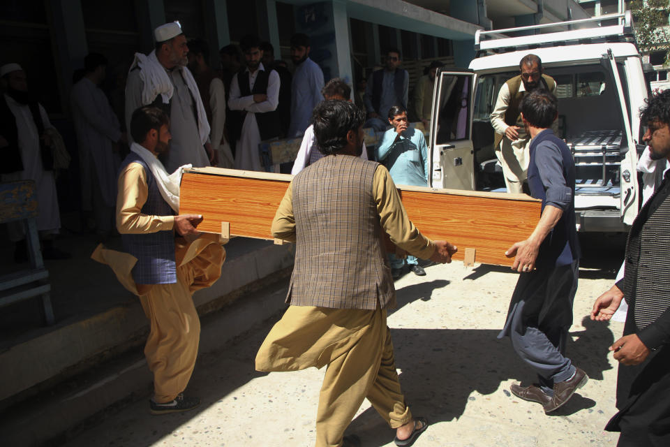Afghans carry the body of a woman who was killed by gunmen in the city of Jalalabad, east of Kabul, Afghanistan, Tuesday, March 30, 2021. Attackers on Tuesday gunned down three women working to administer the anti-polio vaccine in eastern Afghanistan, officials said, a day after authorities launched a new campaign against the crippling children's disease. (AP Photo)