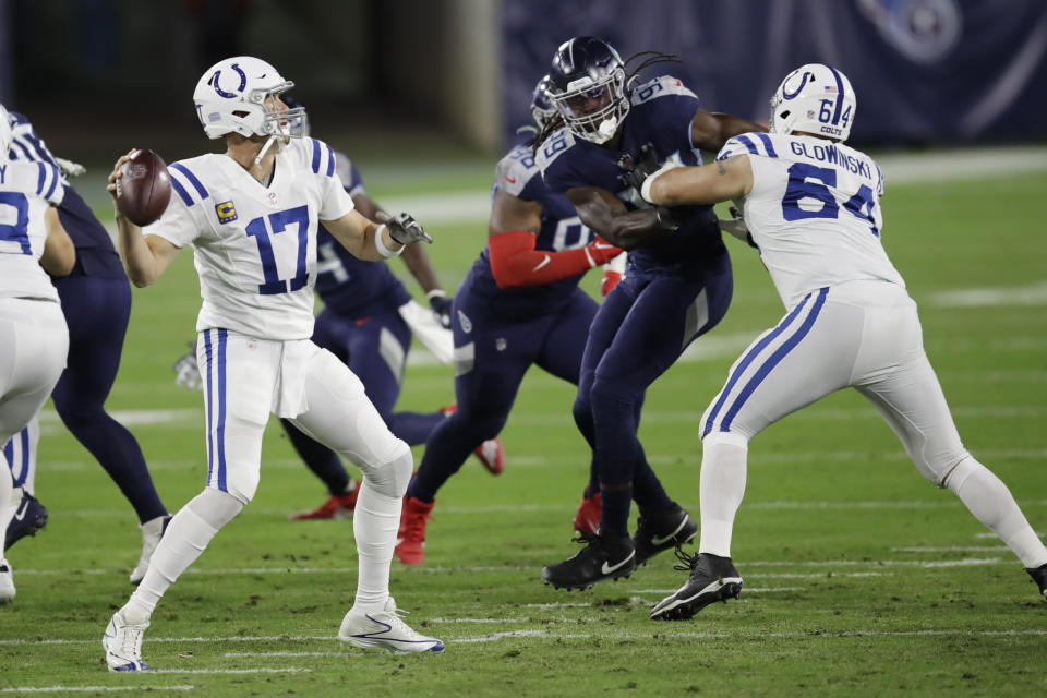 Indianapolis Colts quarterback Philip Rivers (17) passes as offensive guard Mark Glowinski (64) blocks Tennessee Titans linebacker Jadeveon Clowney (99) in the first half of an NFL football game Thursday, Nov. 12, 2020, in Nashville, Tenn. (AP Photo/Ben Margot)