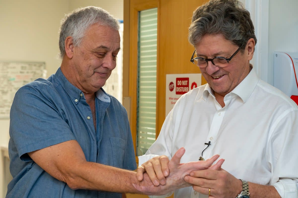 Hand transplant patient Mark Cahill with surgeon Simon Kay at Leeds General Infirmary (PA)