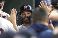 Houston Astros' Jose Altuve celebrates in the dugout after hitting a home run against the New York Mets during the third inning of a baseball game Tuesday, June 21, 2022, in Houston. (AP Photo/David J. Phillip)