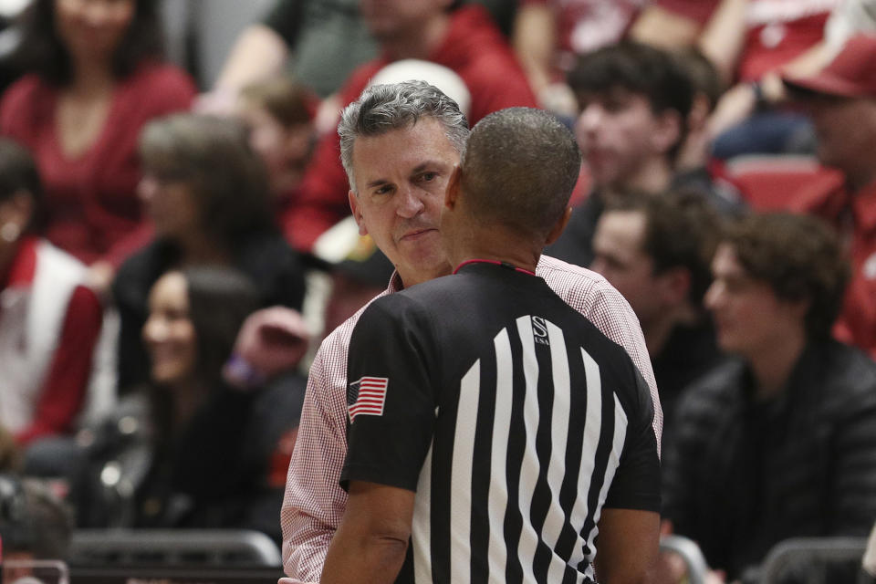 Washington State head coach Kyle Smith, left, speaks with an official after being called for a technical foul during the second half of an NCAA college basketball game against Colorado, Saturday, Jan. 27, 2024, in Pullman, Wash. Washington State won 78-69. (AP Photo/Young Kwak)