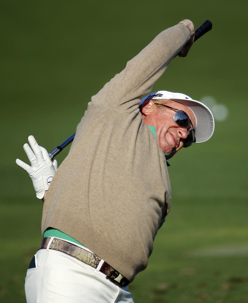 Miguel Angel Jimenez, of Spain, stretches before hitting on the driving range during a practice round for the Masters golf tournament Wednesday, April 9, 2014, in Augusta, Ga. (AP Photo/Matt Slocum)