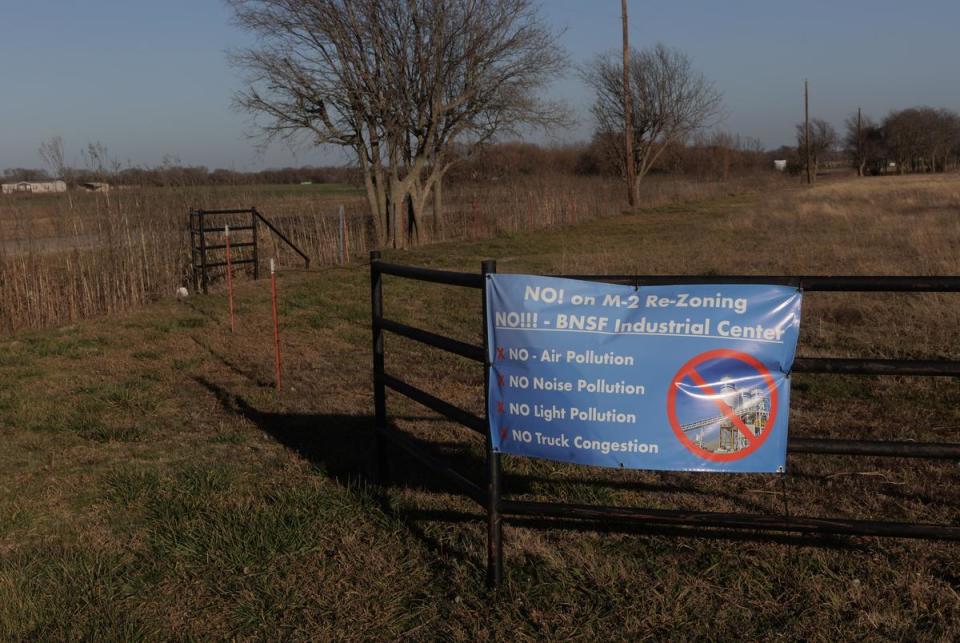 Residents neighboring the BNSF property boundary have signs placed on their fences and lining the road opposing the BNSF logistic center project in Gunter, TX on January 11, 2024.