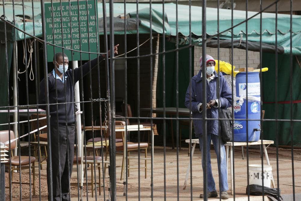 A man is turned away by a guard after he tried to get the Sinopharm coronavirus vaccine at a health facility in Harare, Zimbabwe, Tuesday, June, 8, 2021. (AP Photo/Tsvangirayi Mukwazhi)