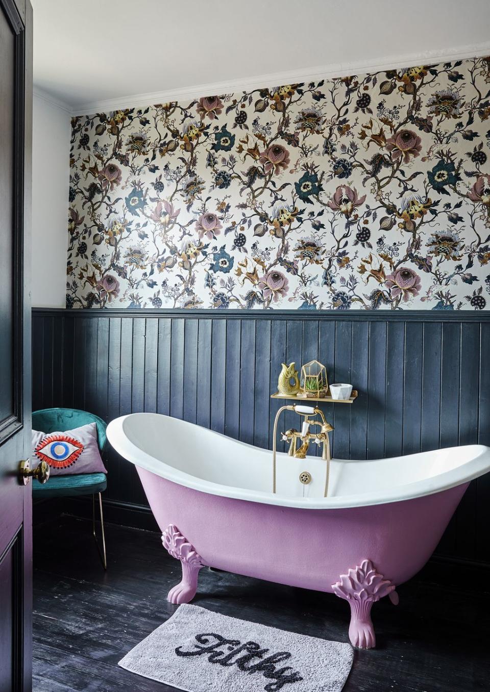 navy blue panelled bathroom with pink freestanding bath