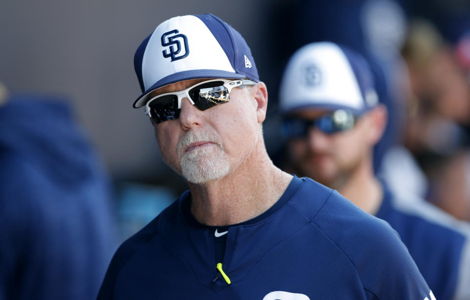 San Diego Padres bench coach Mark McGwire walks in the dugout during the fifth inning of a spring training baseball game against the Kansas City Royals, Friday, March 2, 2018, in Peoria, Ariz. (AP Photo/Charlie Neibergall)