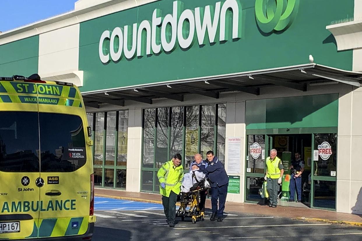 First responders take a victim to an ambulance outside a Countdown supermarket in central Dunedin, New Zealand, Monday May 10, 2021.