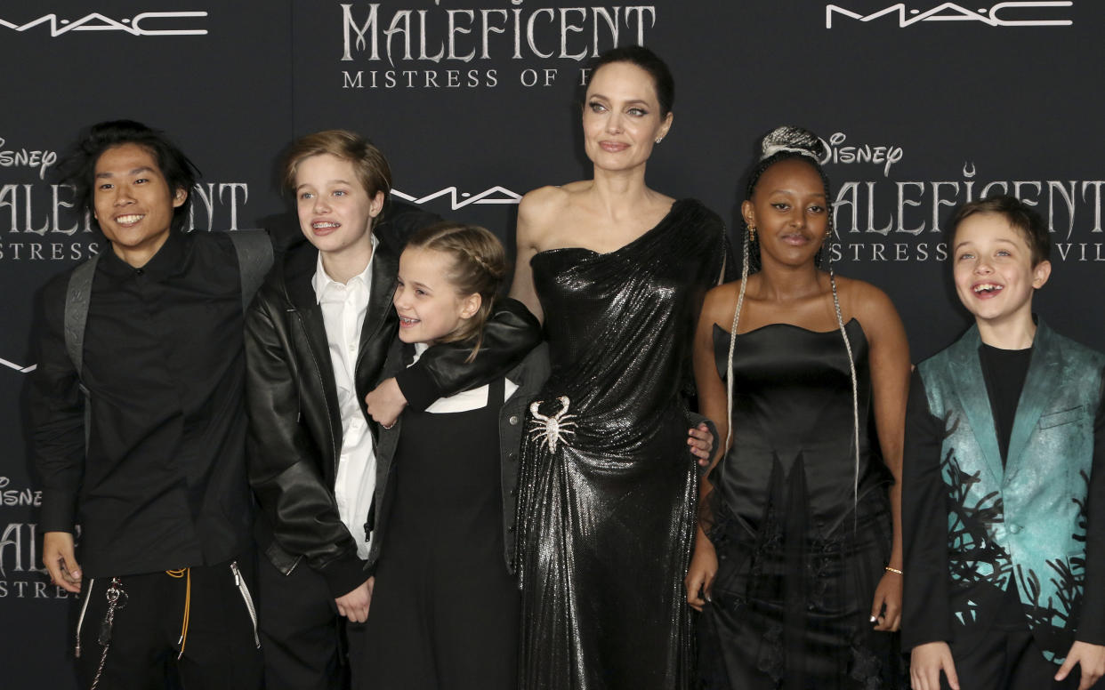 CORRECTS TO PAX JOLIE-PITT, NOT MADDOX JOLIE-PITT - Angelina Jolie, third right, and her children, from left, Pax Jolie-Pitt, Shiloh Jolie-Pitt, Vivienne Jolie-Pitt, Zahara Jolie-Pitt and Knox Jolie-Pitt arrive at the world premiere of "Maleficent: Mistress of Evil" on Monday, Sept. 30, 2019, at the El Capitan Theatre in Los Angeles. (Photo by Willy Sanjuan/Invision/AP)