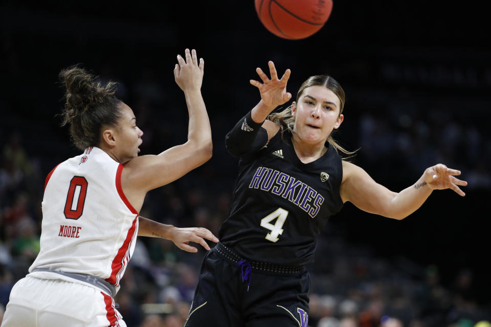 Washington's Amber Melgoza (4) passes around Utah's Kiana Moore (0) during the first half of an NCAA college basketball game in the first round of the Pac-12 women's tournament Thursday, March 5, 2020, in Las Vegas. (AP Photo/John Locher)