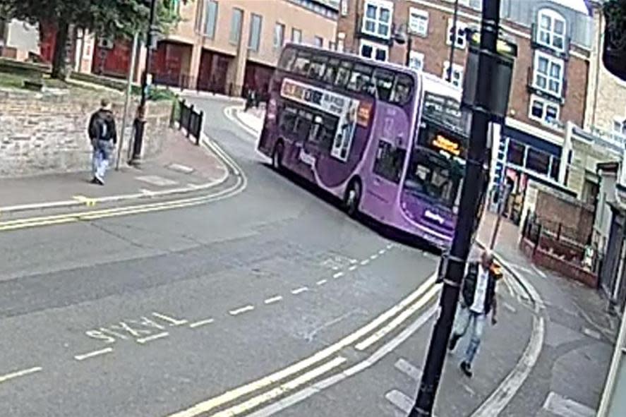 The bus comes hurtling around the corner in a busy shopping area of central Reading (PA)