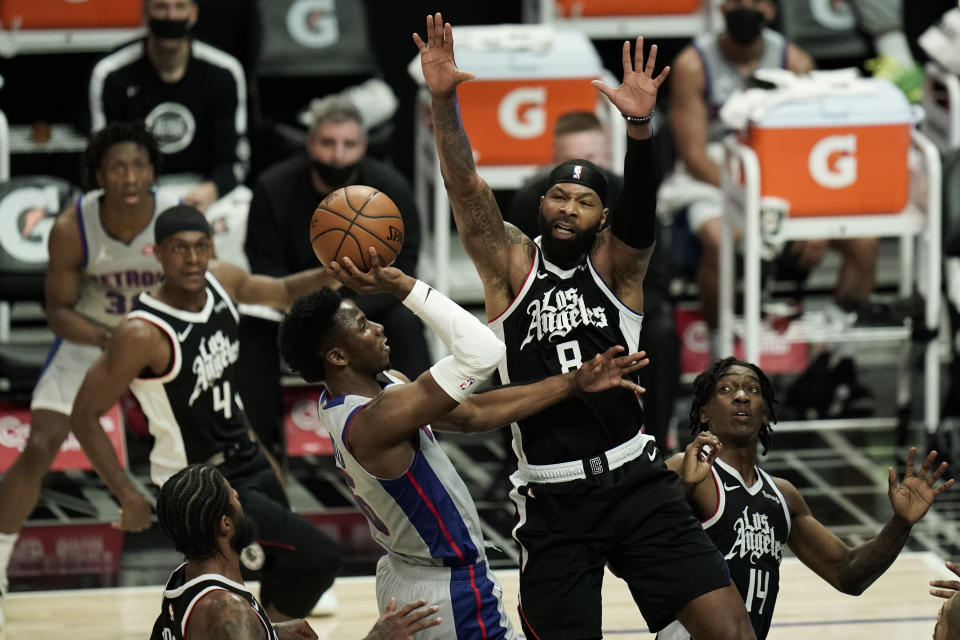 Detroit Pistons' Hamidou Diallo, center left, drives to the basket under defense by Los Angeles Clippers' Marcus Morris Sr. during the first half of an NBA basketball game Sunday, April 11, 2021, in Los Angeles. (AP Photo/Jae C. Hong)