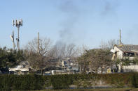 Smoke fills the sky after a massive explosion rocks west Houston Friday, Jan. 24, 2020, in Houston. A massive explosion early Friday leveled a warehouse in Houston and damaged nearby buildings and homes, rousing frightened people from their sleep miles away. (Marie D. De Jesús/Houston Chronicle via AP)